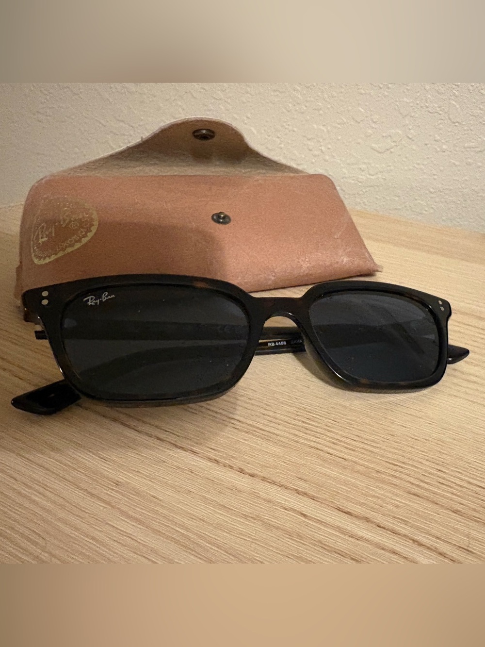 Ray-Ban Black Sunglasses with blue lenses.